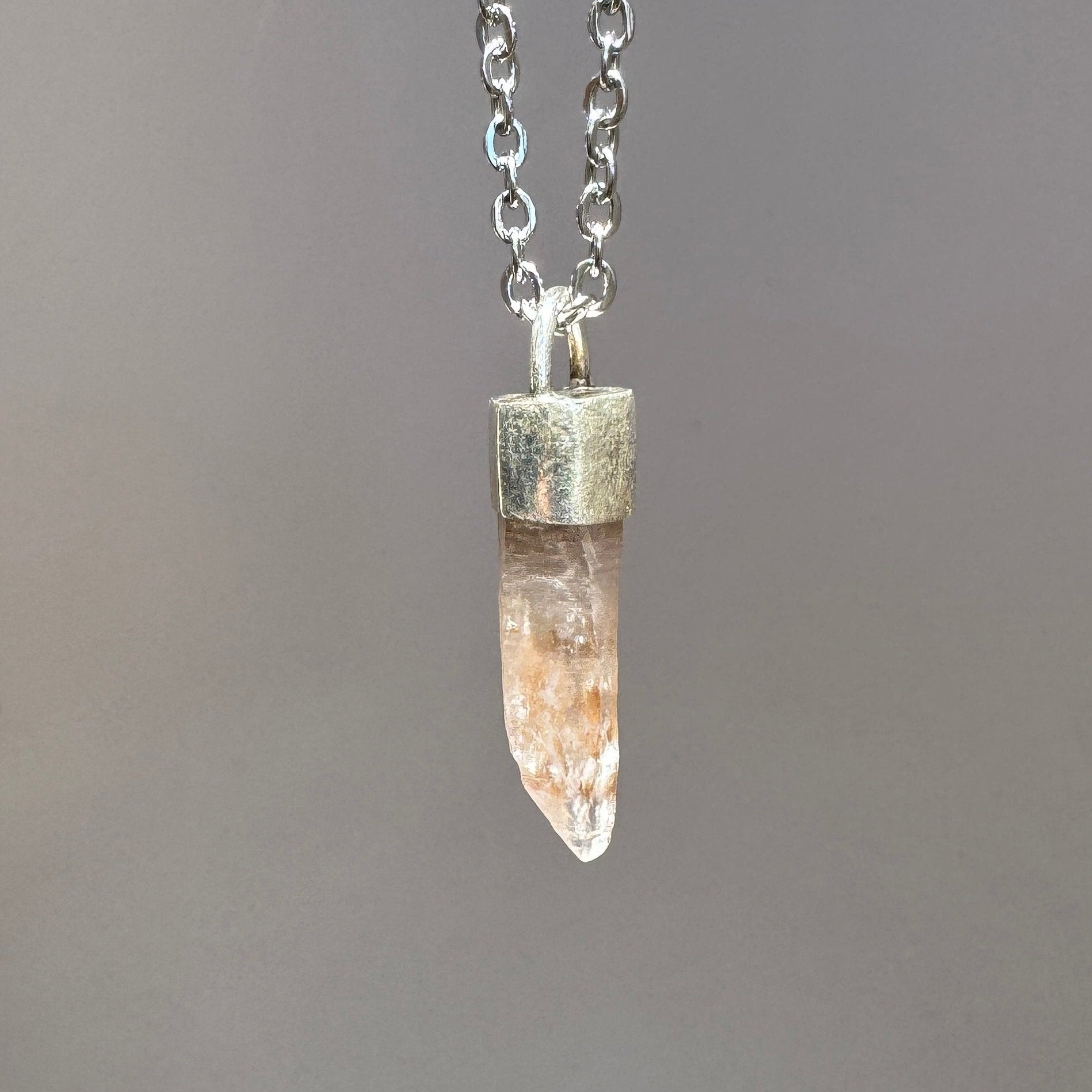 Raw uncut tangerine quartz pendant on oxidized sterling silver base